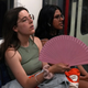 A woman holds a fan as she travels on the London Underground during a heatwave in London, Britain, July 17, 2022.